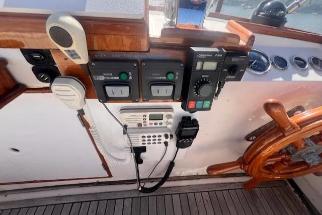 Slide: The Image of Control panel of a 1980 Grand Banks 32 Flybridge Trawler with steering wheel and communication devices. - 18