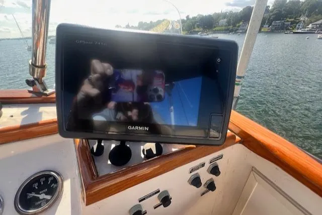 Slide: The Image of Garmin GPS on 1980 Grand Banks 32 Flybridge Trawler, overlooking serene waters. - 19
