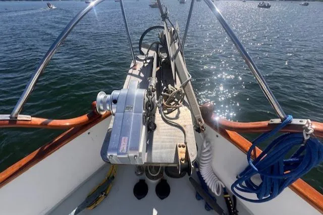 Slide: The Image of 1980 Grand Banks 32 Flybridge Trawler bow with anchor and ropes on sunny water. - 24