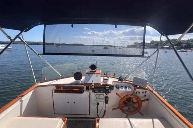 Slide: The Image of 1980 Grand Banks 32 Flybridge Trawler helm with scenic water view. - 25