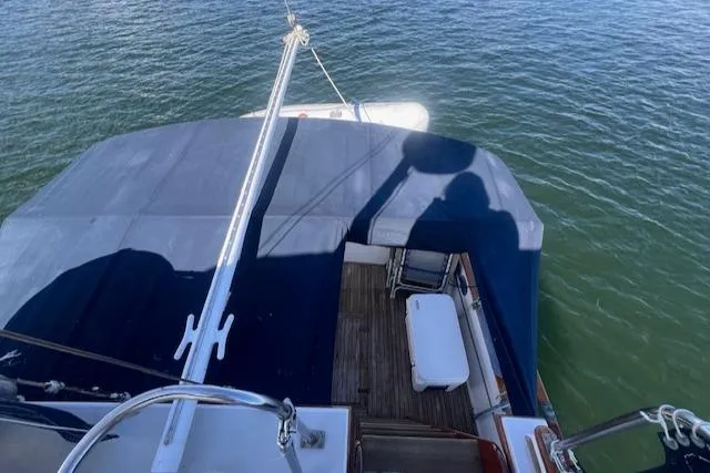 Slide: The Image of 1980 Grand Banks 32 Flybridge Trawler, view from above, docked on calm water. - 26
