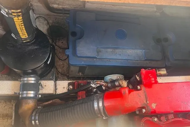 Slide: The Image of Engine compartment of 1980 Grand Banks 32 Flybridge Trawler, showing mechanical components and battery. - 31