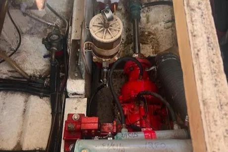 Slide: The Image of Engine compartment of 1980 Grand Banks 32 Flybridge Trawler, showcasing mechanical components. - 32