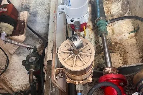 Slide: The Image of Engine room components of a 1980 Grand Banks 32 Flybridge Trawler, featuring various mechanical parts. - 34