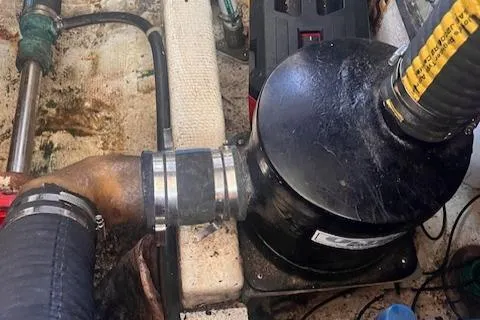 Slide: The Image of Engine compartment of 1980 Grand Banks 32 Flybridge Trawler, showing mechanical components and hoses. - 35