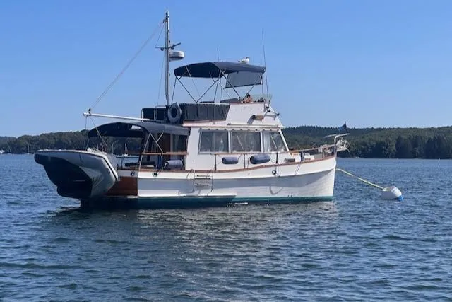 Slide: The Image of 1980 Grand Banks 32 Flybridge Trawler on calm water, showcasing classic design and elegance. - 39