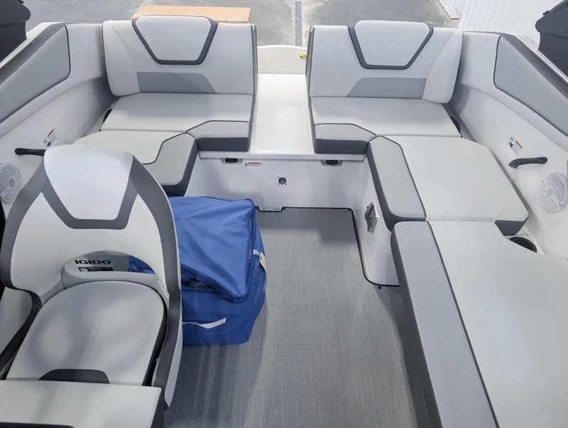 Slide: The Image of 2025 Yamaha Boats AR220 interior with gray seating and blue cooler. - 10