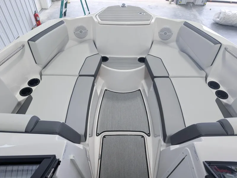 Slide: The Image of 2025 Yamaha Boats AR220 interior with gray seating and cup holders. - 11