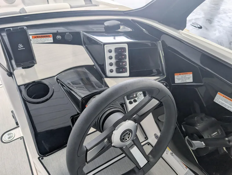 Slide: The Image of 2025 Yamaha Boats AR220 dashboard with steering wheel and control panel. - 7