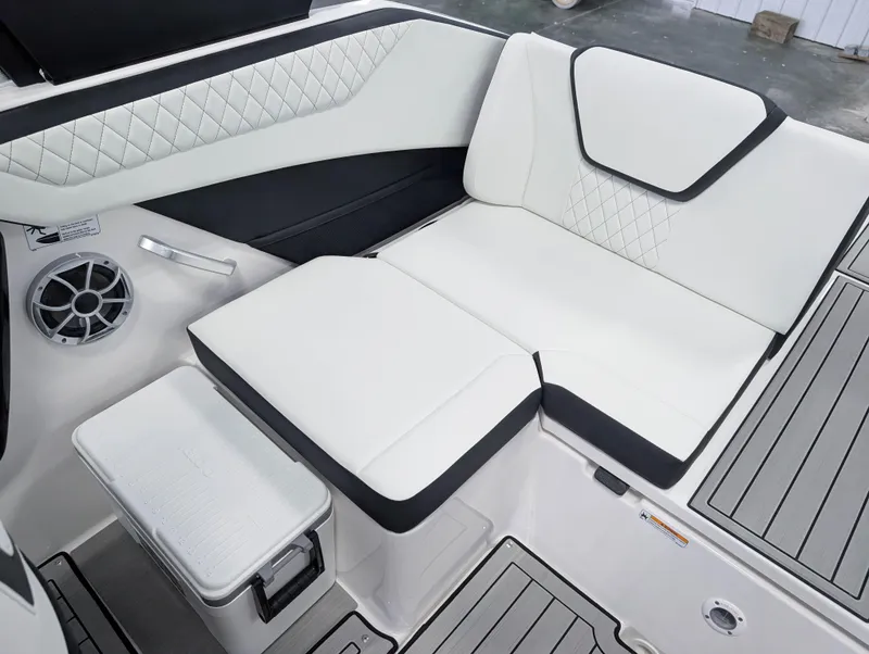 Slide: The Image of 2025 Yamaha Boats 222SE interior seating with white upholstery and integrated speaker. - 18