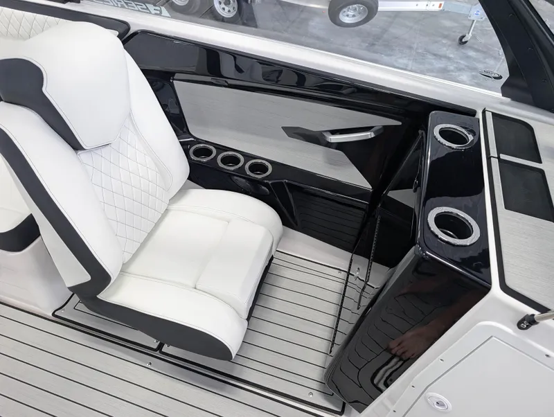 Slide: The Image of 2025 Yamaha Boats 222SE interior with white seating and cup holders. - 21