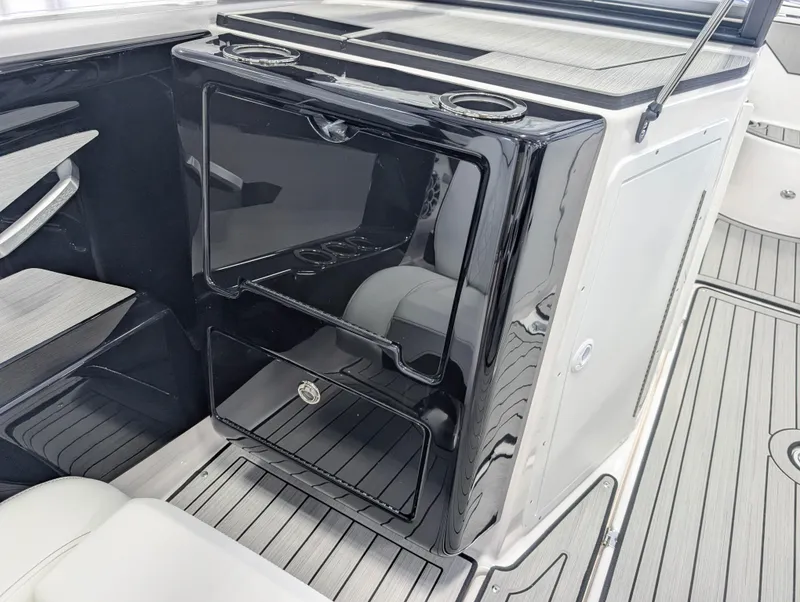 Slide: The Image of 2025 Yamaha Boats 222SE interior with sleek black cabinetry and modern design elements. - 22