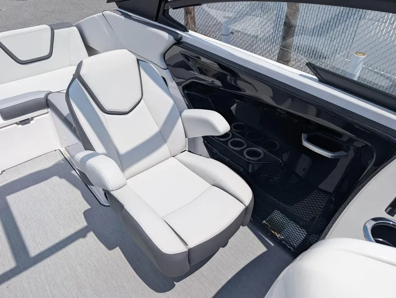 Slide: The Image of 2025 Yamaha Boats AR250 interior with sleek seating and cup holders. - 11