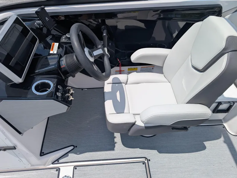 Slide: The Image of 2025 Yamaha AR250 boat cockpit with steering wheel and white captain's chair. - 13