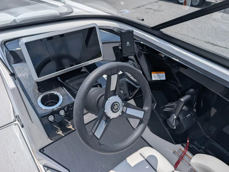 Slide: The Image of 2025 Yamaha AR250 boat dashboard with steering wheel and touchscreen display. - 14