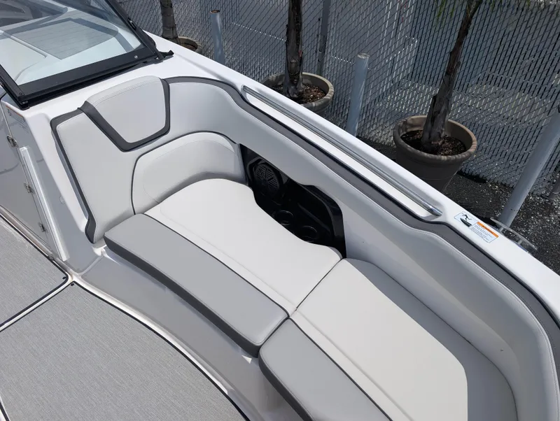 Slide: The Image of 2025 Yamaha AR250 boat interior with sleek white seating and modern design. - 16