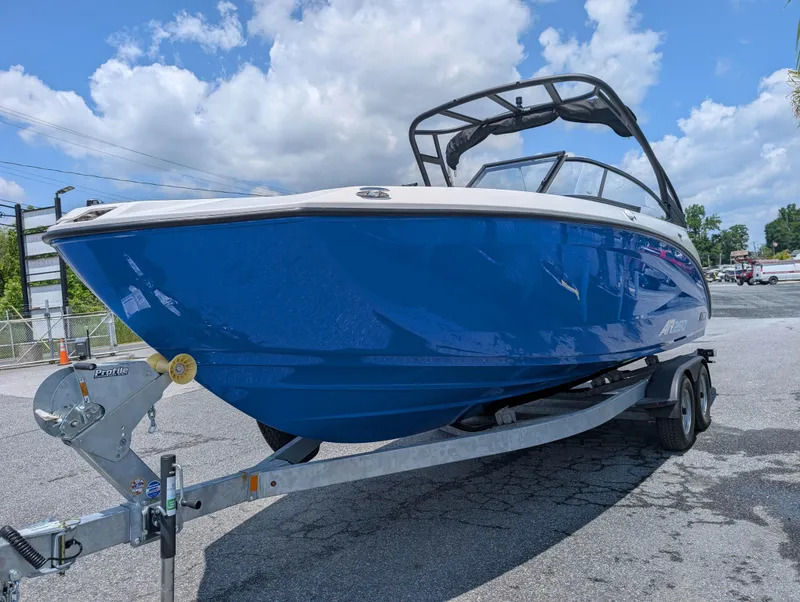 Slide: The Image of 2025 Yamaha Boats AR250 on trailer, blue hull, sunny day, parked outdoors. - 4