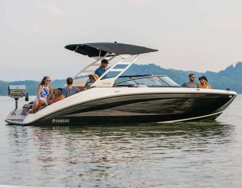 Slide: The Image of 2025 Yamaha Boats 252SD on water with passengers enjoying a sunny day. - 9