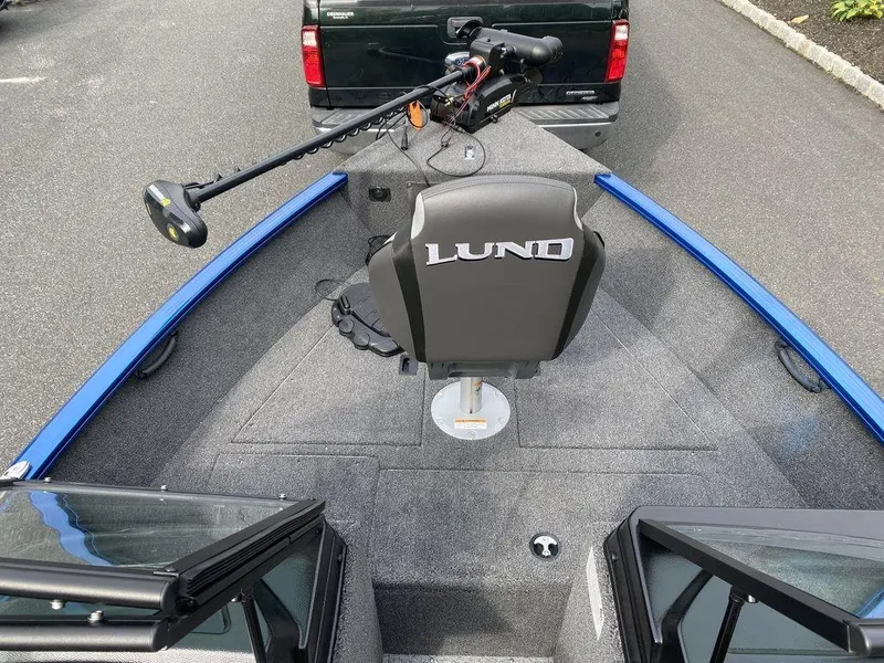 Slide: The Image of 2025 Lund 1650 Rebel XL boat interior with trolling motor and seating. - 12