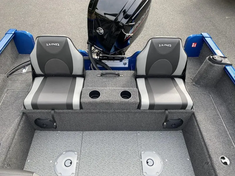 Slide: The Image of 2025 Lund 1650 Rebel XL boat interior with dual seats and motor. - 15