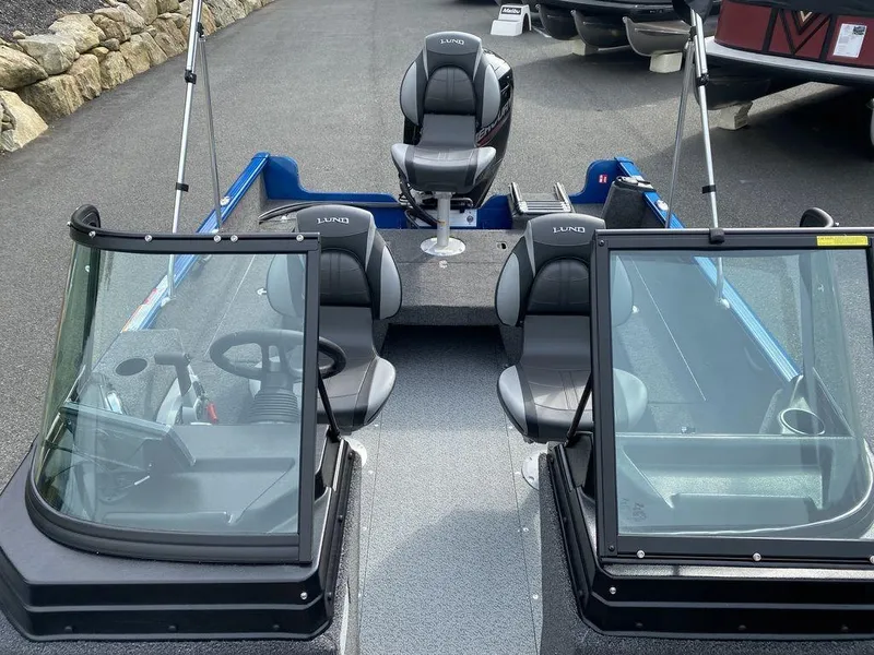 Slide: The Image of 2025 Lund 1650 Rebel XL boat interior with seating and steering console. - 16