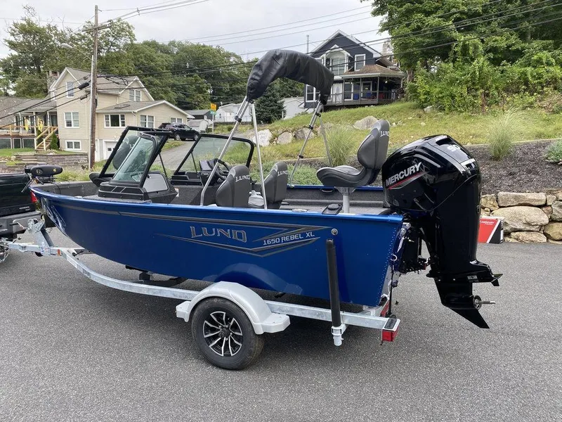 Slide: The Image of 2025 Lund 1650 Rebel XL boat with Mercury engine on trailer. - 17