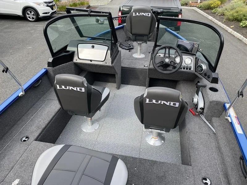 Slide: The Image of 2025 Lund 1650 Rebel XL boat interior with seating and steering console. - 3