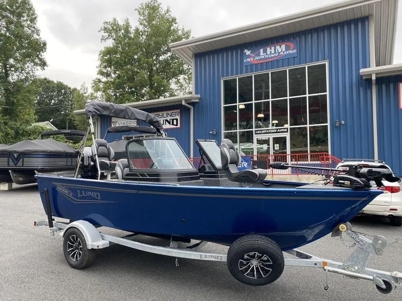 Slide: The Image of 2025 Lund 1650 Rebel XL boat on trailer outside dealership. - 5