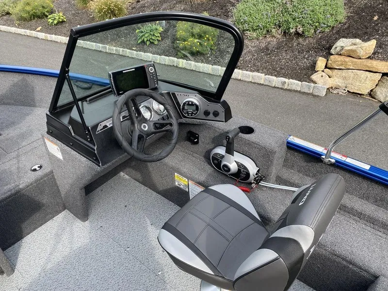 Slide: The Image of 2025 Lund 1650 Rebel XL boat interior with steering wheel and control panel. - 6