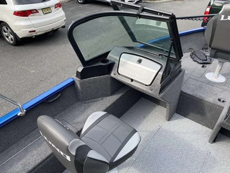 Slide: The Image of 2025 Lund 1650 Rebel XL boat interior with seating and windshield. - 9