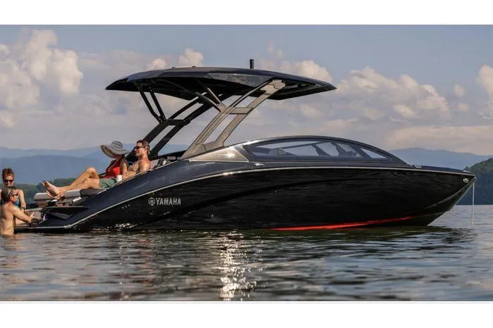 Slide: The Image of 2025 Yamaha Boats 275 SD on calm water with passengers enjoying the sun. - 11