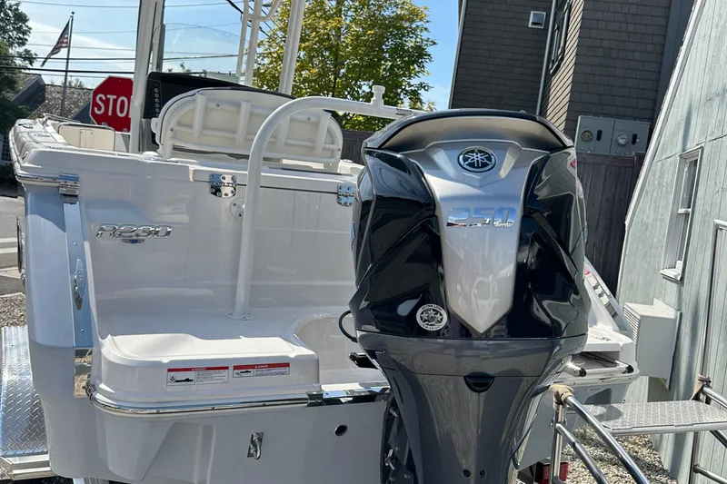 Slide: The Image of 2025 Robalo R230 Center Console boat with Yamaha outboard motor, docked outdoors. - 4