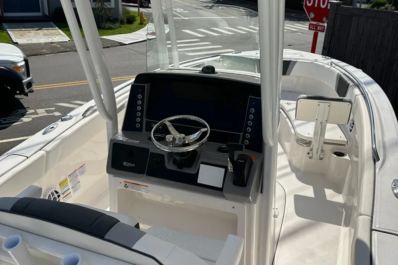 Slide: The Image of 2025 Robalo R230 Center Console boat interior with steering wheel and dashboard. - 5
