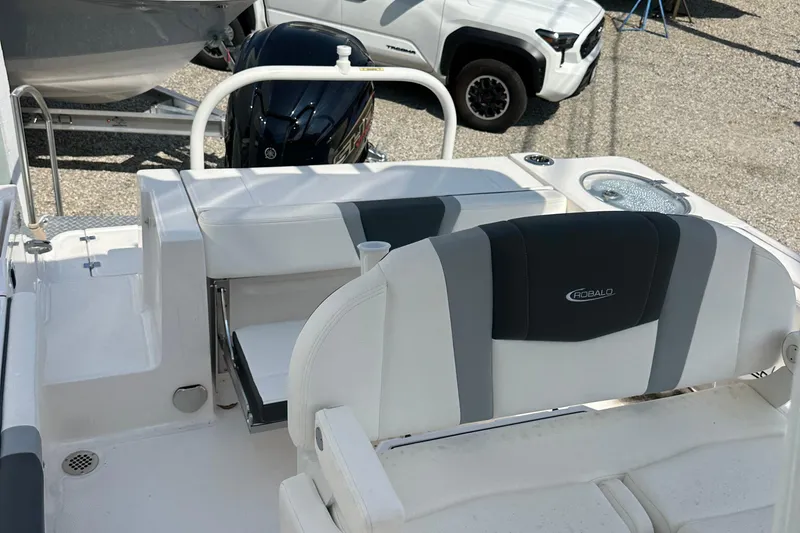 Slide: The Image of 2025 Robalo R230 Center Console boat interior with seating and motor. - 7