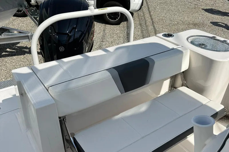Slide: The Image of 2025 Robalo R230 Center Console boat interior with seating and motor detail. - 8