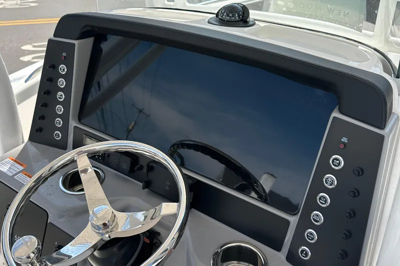 Slide: The Image of 2025 Robalo R230 Center Console dashboard with steering wheel and control panel. - 9