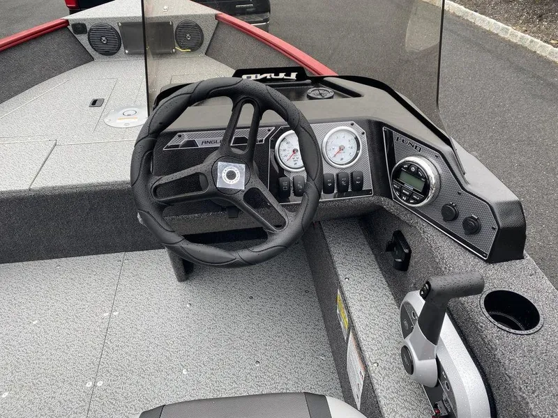 Slide: The Image of 2025 Lund 1650 Angler boat dashboard with steering wheel and gauges. - 10