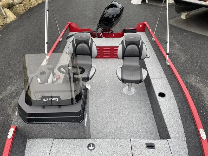 Slide: The Image of 2025 Lund 1650 Angler boat interior with two seats and steering console. - 9