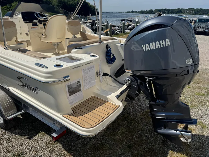 Slide: The Image of 2025 Scout 215 Dorado boat with Yamaha outboard motor, docked near a scenic waterfront. - 10