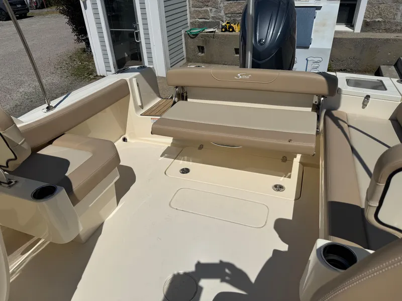 Slide: The Image of 2025 Scout 215 Dorado boat interior with beige seating and cup holders. - 17
