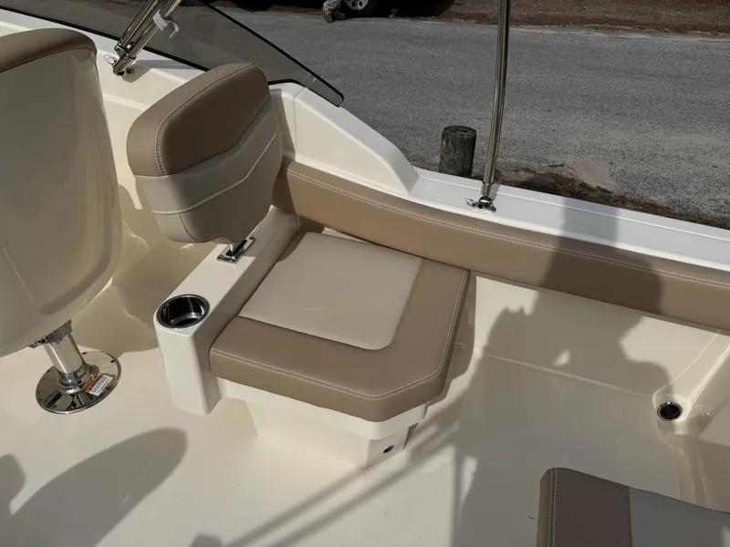 Slide: The Image of 2025 Scout 215 Dorado boat interior with beige seating and cup holder. - 23