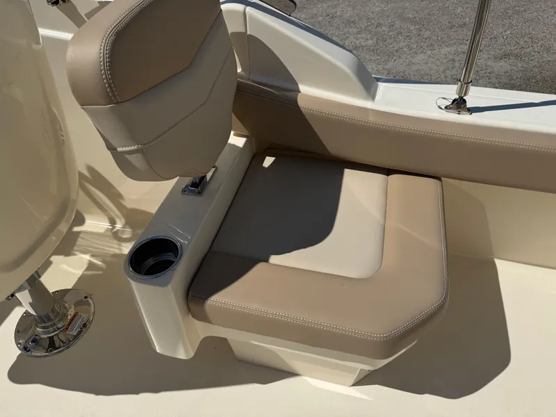 Slide: The Image of 2025 Scout 215 Dorado boat seat with beige upholstery and integrated cup holder. - 24