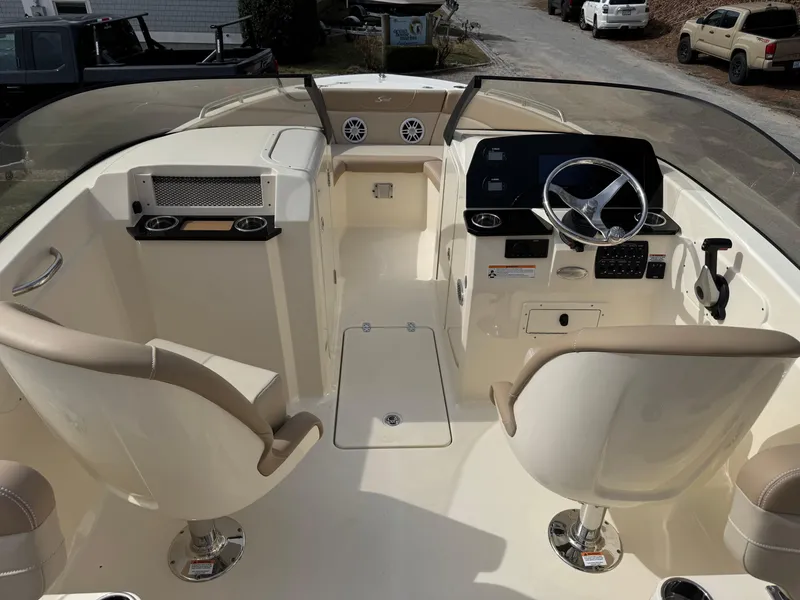 Slide: The Image of 2025 Scout 215 Dorado boat interior with dual seats and modern dashboard. - 25