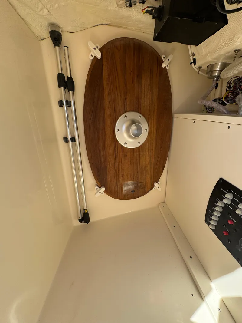 Slide: The Image of Interior view of 2025 Scout 215 Dorado boat, featuring wooden panel and control panel. - 26