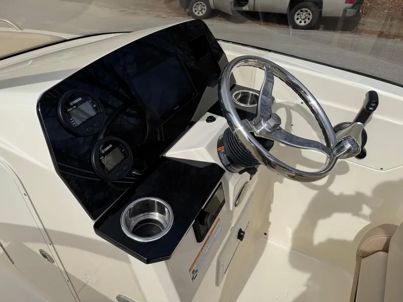 Slide: The Image of 2025 Scout 215 Dorado boat dashboard with steering wheel and gauges. - 30