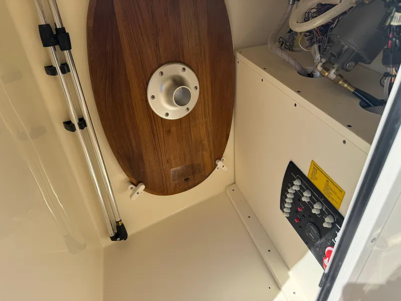 Slide: The Image of Interior view of 2025 Scout 215 Dorado boat, featuring control panel and wooden table. - 31