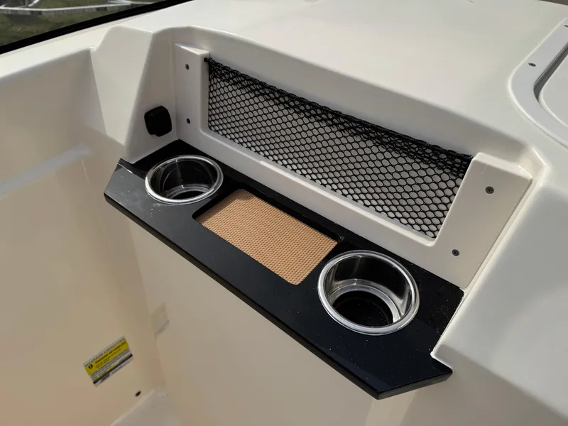 Slide: The Image of 2025 Scout 215 Dorado boat console with cup holders and storage net. - 32