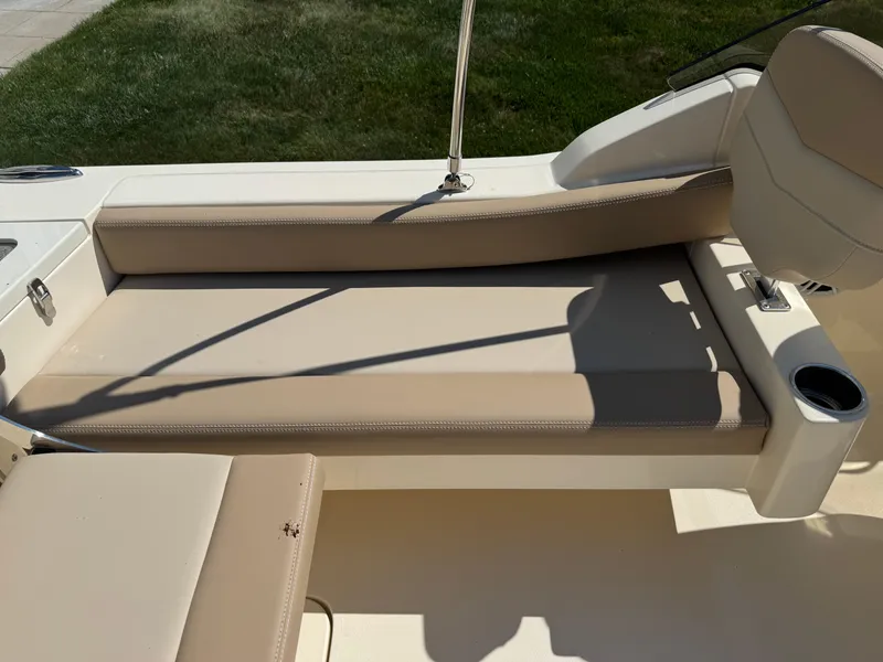 Slide: The Image of 2025 Scout 215 Dorado boat interior with beige seating and cup holder. - 35