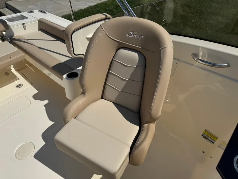Slide: The Image of 2025 Scout 215 Dorado boat seat with beige upholstery and cup holder. - 36