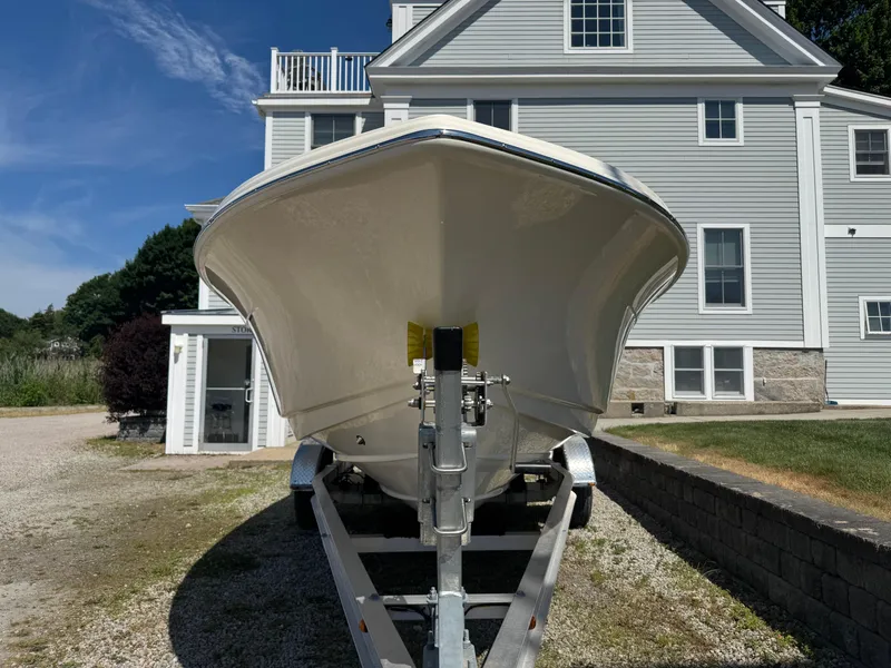 Slide: The Image of 2025 Scout 215 Dorado boat on trailer, parked in front of a house. - 4
